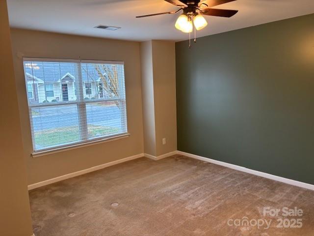 unfurnished room with carpet floors and ceiling fan