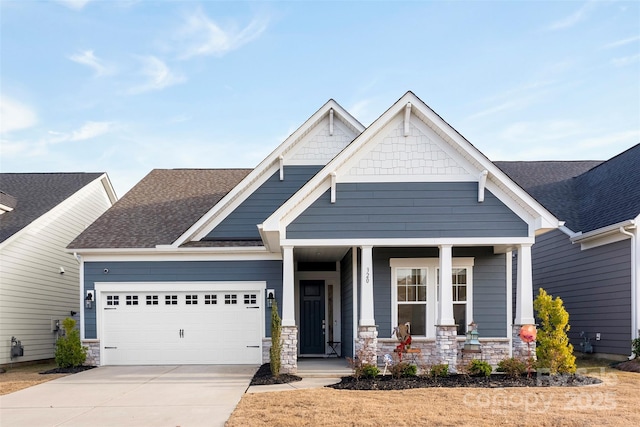 craftsman house with an attached garage, covered porch, concrete driveway, stone siding, and roof with shingles