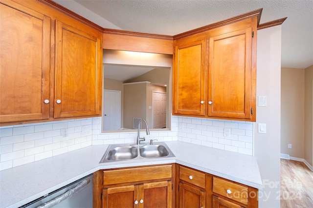 kitchen with dishwasher, decorative backsplash, a textured ceiling, and sink