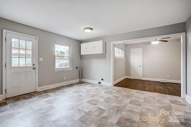 clothes washing area featuring ceiling fan, hookup for a washing machine, and cabinets