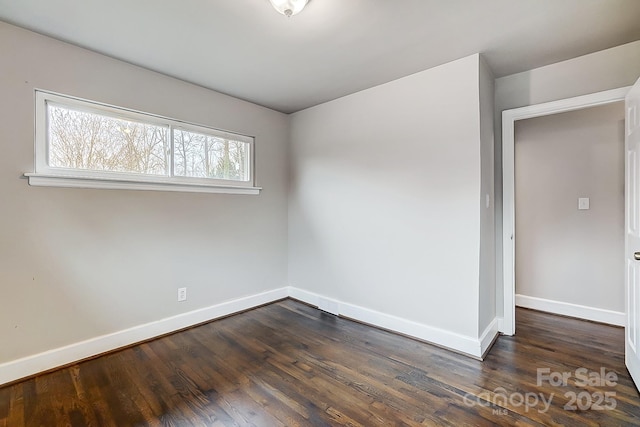 empty room with dark hardwood / wood-style floors