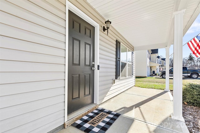 view of exterior entry with covered porch