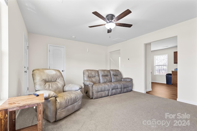 living room featuring carpet and ceiling fan