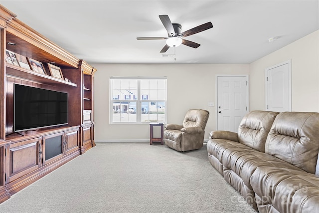 carpeted living room with ceiling fan