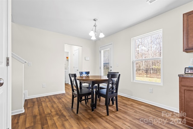 dining room with a chandelier and dark hardwood / wood-style floors