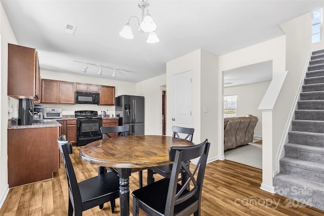 dining room featuring dark hardwood / wood-style floors and an inviting chandelier