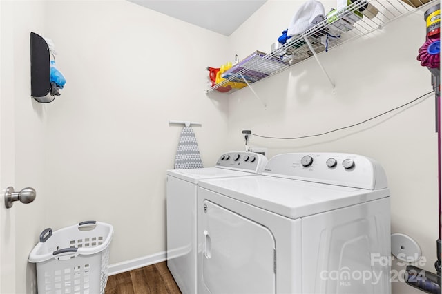 washroom with washer and clothes dryer and dark wood-type flooring