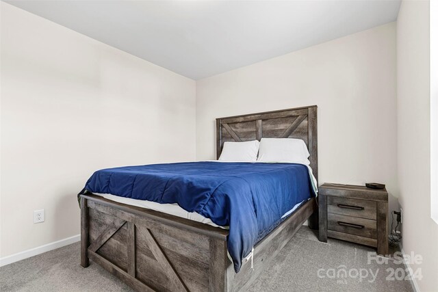 bedroom featuring light colored carpet