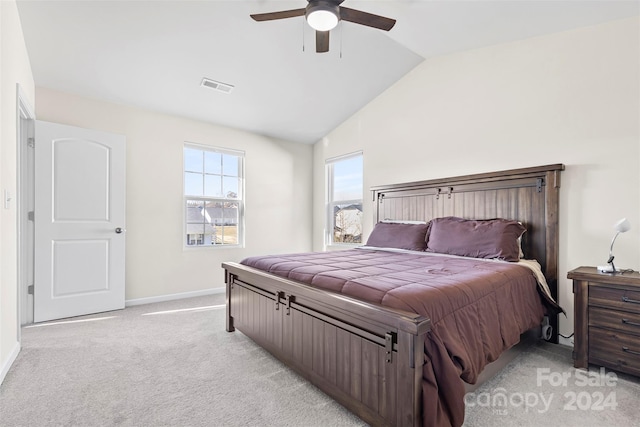 bedroom featuring ceiling fan, light colored carpet, and vaulted ceiling