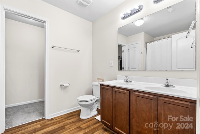 bathroom featuring hardwood / wood-style flooring, vanity, and toilet