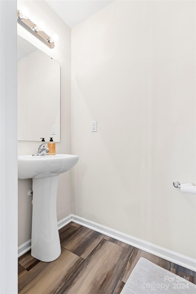 bathroom with hardwood / wood-style floors