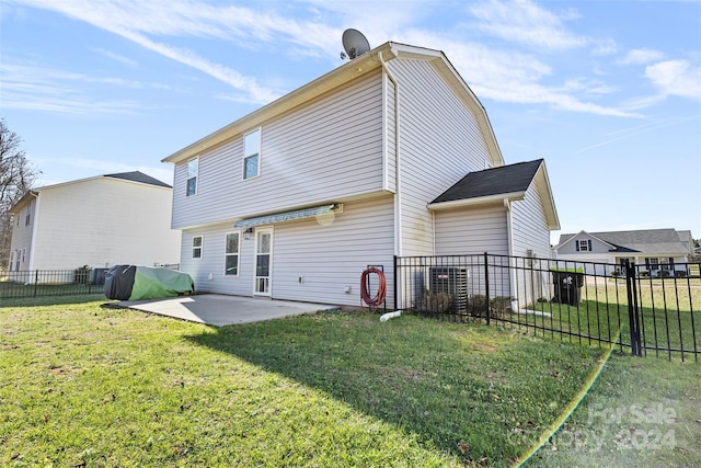 rear view of house with a patio area and a lawn