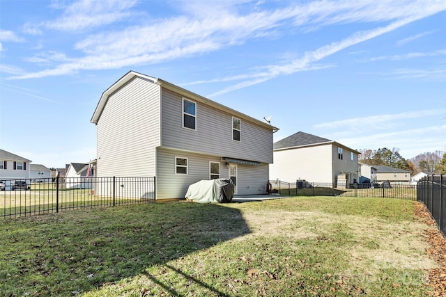 back of house featuring a patio and a lawn