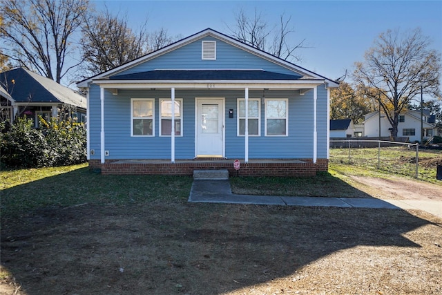 bungalow-style home with a front yard