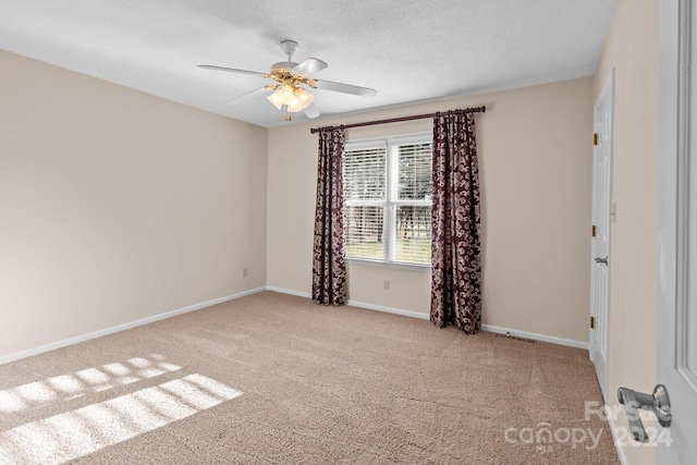 carpeted spare room with ceiling fan and a textured ceiling