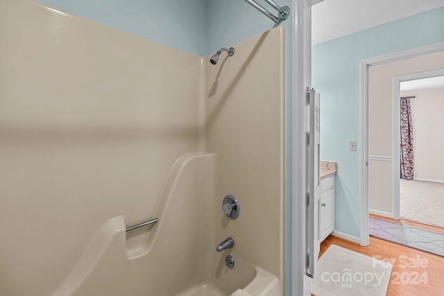 bathroom featuring vanity, shower / bathing tub combination, and wood-type flooring