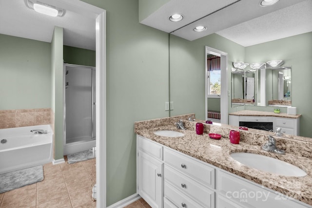 bathroom featuring vanity, a textured ceiling, tile patterned floors, and separate shower and tub