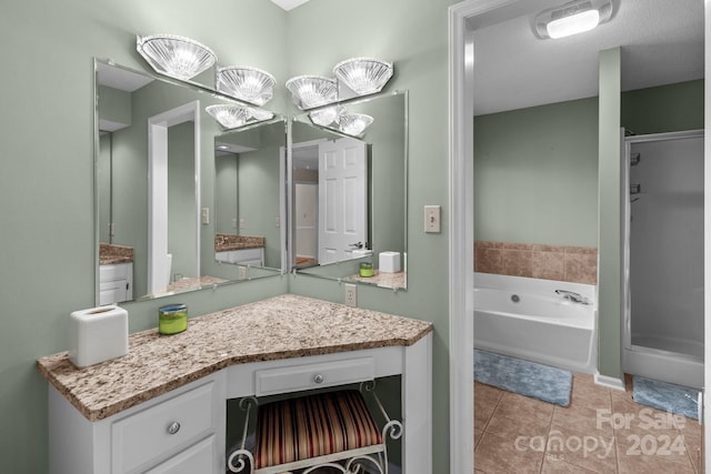 bathroom featuring tile patterned floors, vanity, and shower with separate bathtub