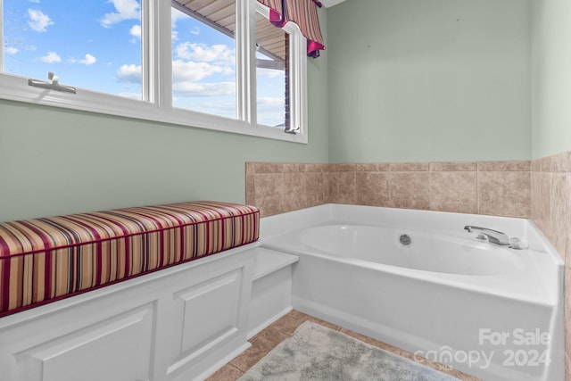 bathroom featuring tile patterned floors and a washtub