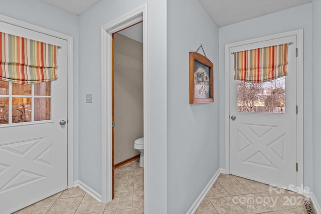 entryway with light tile patterned floors