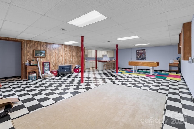 rec room featuring a paneled ceiling, pool table, and wood walls