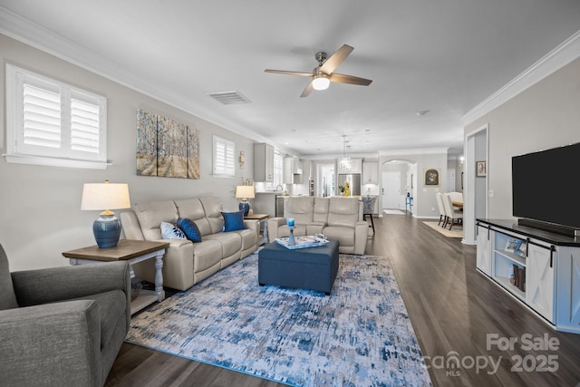 living room featuring ceiling fan, dark hardwood / wood-style floors, and ornamental molding