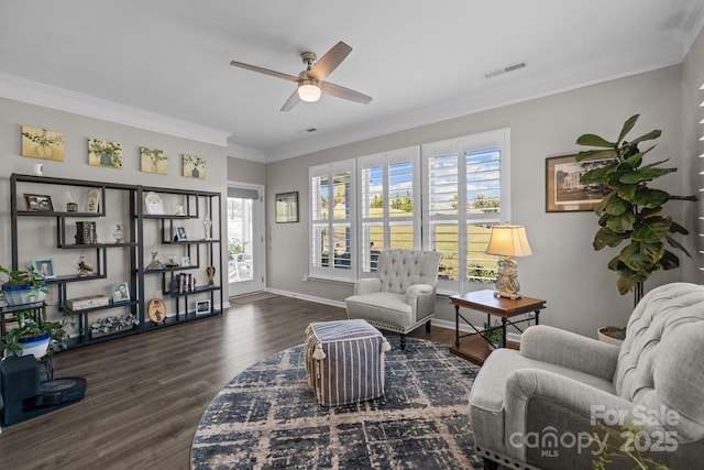 living room featuring ceiling fan, dark wood-type flooring, crown molding, and a healthy amount of sunlight