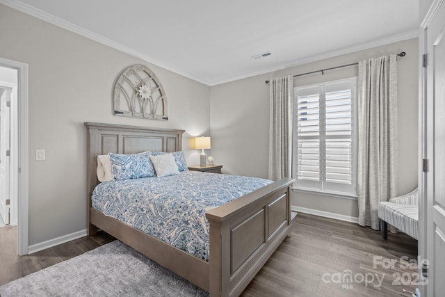 bedroom featuring ornamental molding and hardwood / wood-style flooring