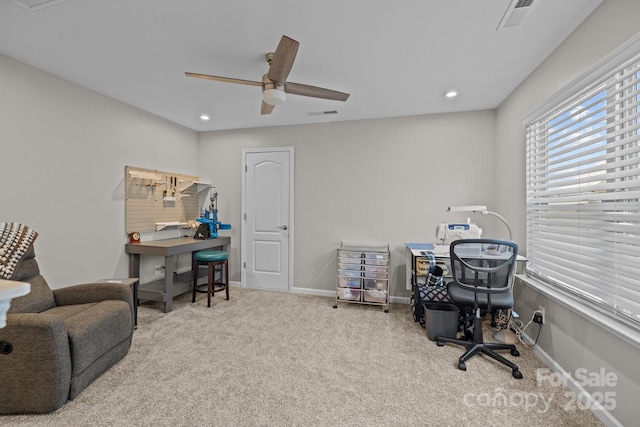 carpeted home office with ceiling fan