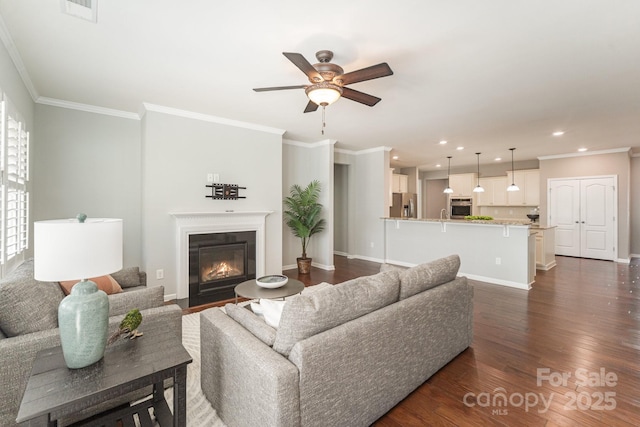 living room featuring ceiling fan, dark wood-type flooring, and ornamental molding