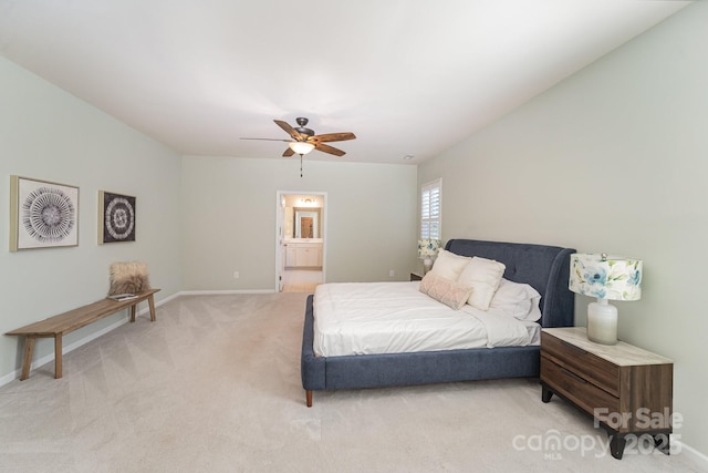 bedroom featuring ceiling fan, ensuite bathroom, and light carpet