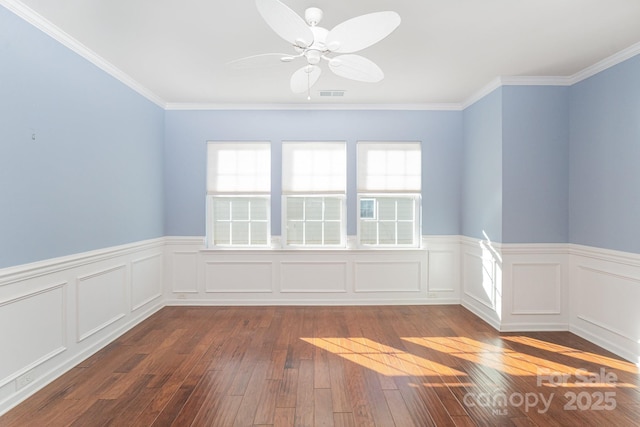 unfurnished room featuring ceiling fan, dark hardwood / wood-style flooring, and ornamental molding