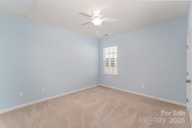 carpeted spare room featuring ceiling fan