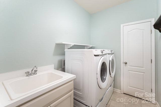 washroom with sink, separate washer and dryer, and light tile patterned flooring