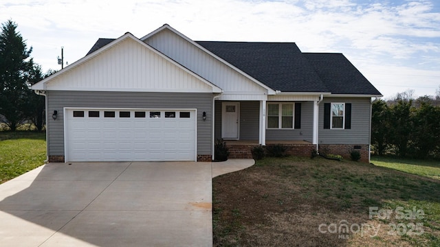 craftsman house with a garage and a front lawn