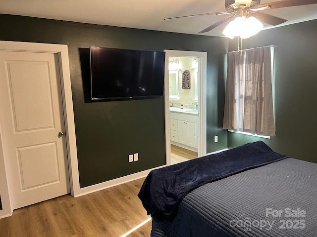 bedroom with light hardwood / wood-style flooring, ceiling fan, and ensuite bathroom