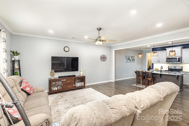 living room with dark hardwood / wood-style flooring, ceiling fan, and crown molding