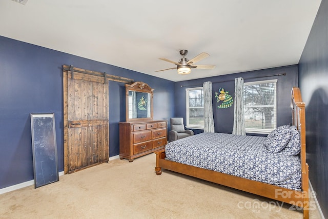 bedroom with carpet, a barn door, and ceiling fan