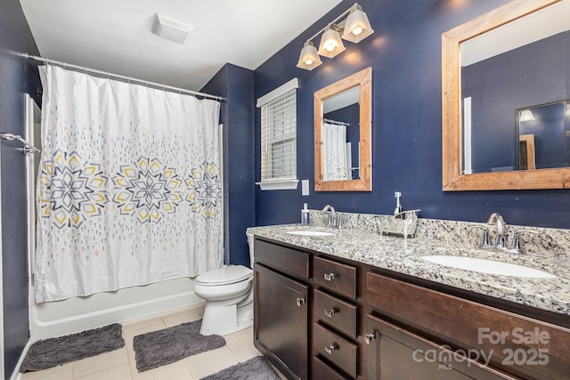 full bathroom featuring toilet, vanity, tile patterned floors, and shower / bath combo with shower curtain