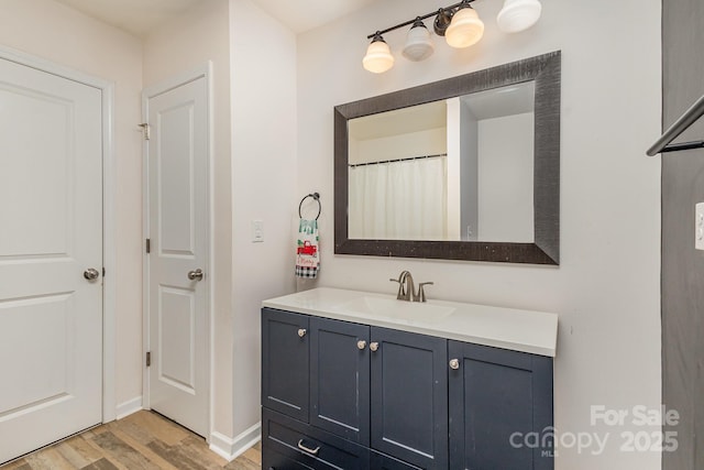 bathroom featuring vanity and wood-type flooring