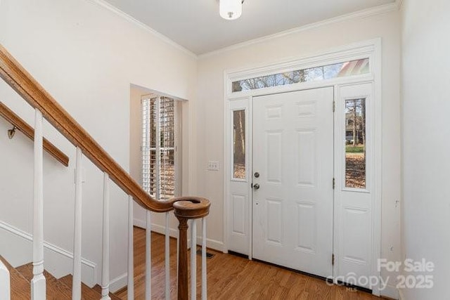 entryway featuring hardwood / wood-style floors and crown molding