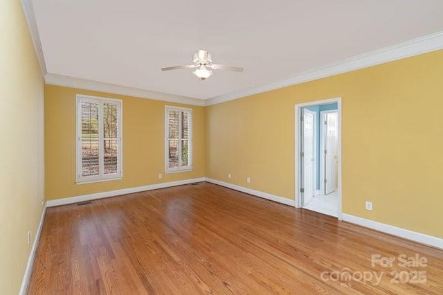 unfurnished room with wood-type flooring, ceiling fan, and crown molding