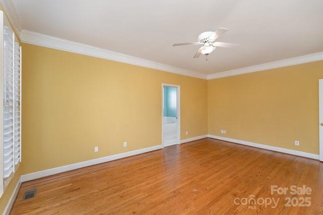 spare room with hardwood / wood-style floors, ceiling fan, and ornamental molding