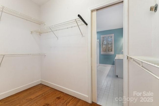 walk in closet featuring hardwood / wood-style floors