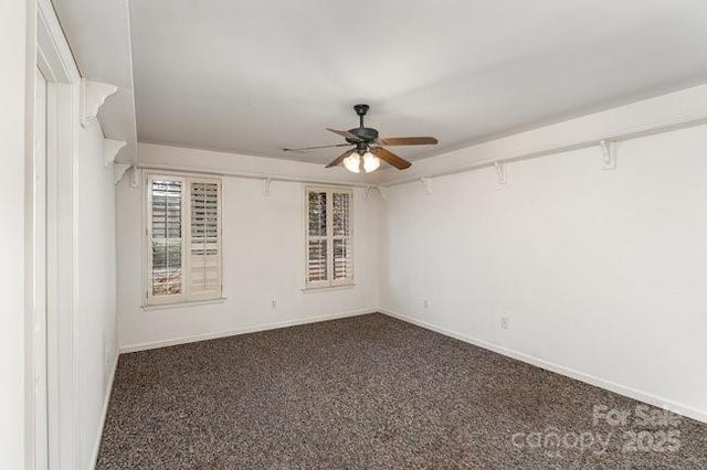 unfurnished room featuring ceiling fan and dark colored carpet