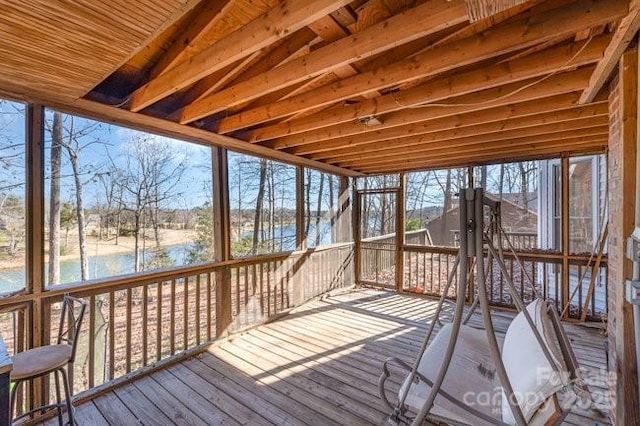 unfurnished sunroom with a water view