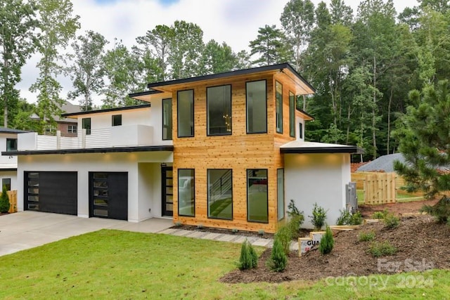 view of front of home with a garage and a front yard