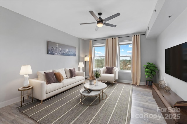 living room featuring light hardwood / wood-style flooring and ceiling fan