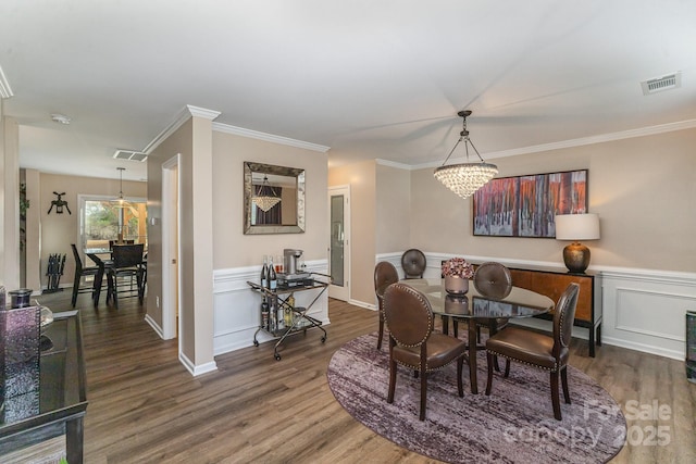 dining space featuring dark wood-type flooring and ornamental molding