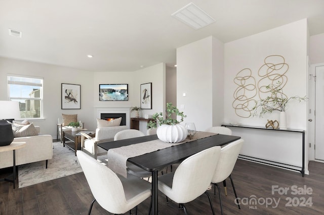 dining area with dark hardwood / wood-style flooring